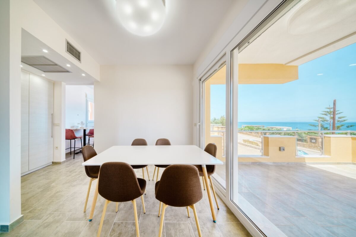 Dining area with balcony access and sea view in Karfas Chios apartment